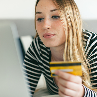 Woman shopping with check or credit card online