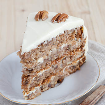 three layer hummingbird cake with white frosting and pecans