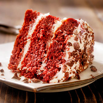 three layered red velvet cake on a plate
