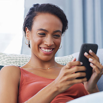 woman uses mobile phone to make zelle transfer